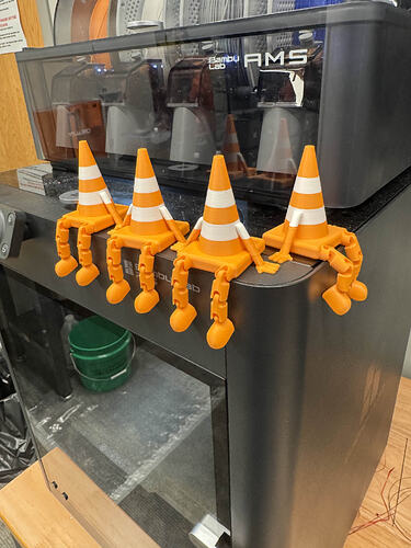A picture of minature, 3D-printed traffic cones for the Convention